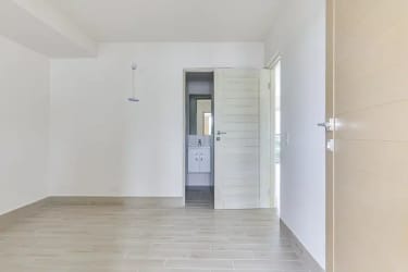 Empty bright bedroom with wood tile flooring and built-in closet in Surfside Punta Chame beach apartment