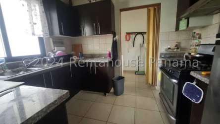 Kitchen with granite countertops and wooden cabinets in Summer Hills Costa Verde Panama