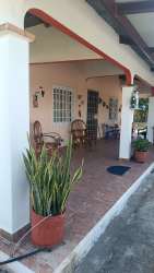 Large yard and covered porch with mature trees at Playas Penonomé house for sale