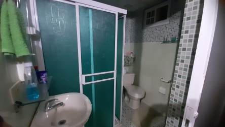 Rustic tiled kitchen with stove, refrigerator, floral curtains in Los Rosales Arraiján Panama