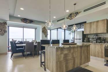 Guest bedroom with large window and ocean view in luxury penthouse of Punta Caelo Panama