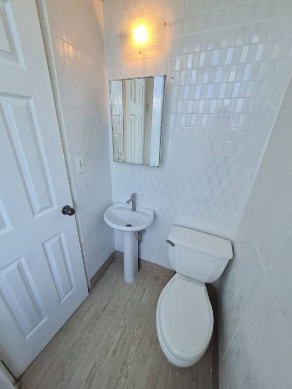 Modern compact bathroom with pedestal sink inside medical office Consultorios San Fernando Panama