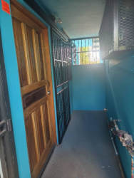 Secure apartment entry hall with blue walls metal bars Edificio Salomón David Panama