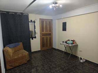 Living room with armchair folding table tile floor David apartment Panama