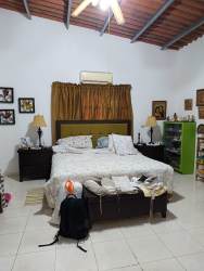 Spacious rustic bedroom with tiled floors and AC unit in country finca Penonomé Coclé Panama