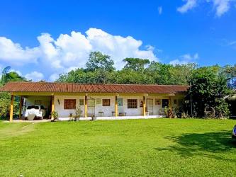 Rustic country kitchen with exposed wood beams and natural light in farm home Penonomé Coclé