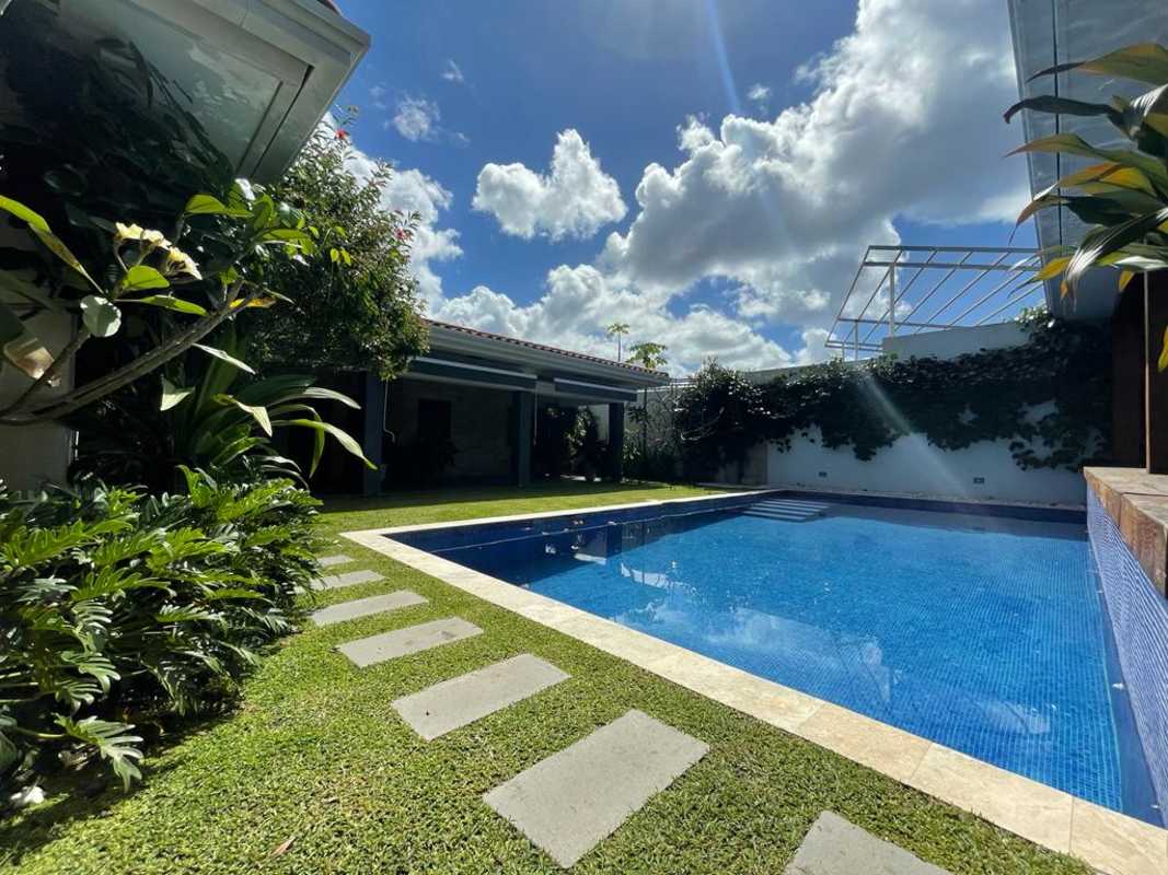 Saltwater private swimming pool surrounded by tropical landscaping in Golf Club house Panama