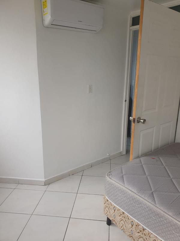 Functional modern kitchen with stove, fridge, and window at PH Limberg Tower Llano Bonito Panama