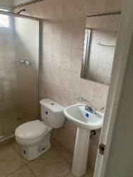 Contemporary bathroom with glass shower enclosure, pedestal sink and tiles in Mystic City home