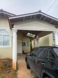 House entry with porch columns and parking space in Mystic City La Chorrera