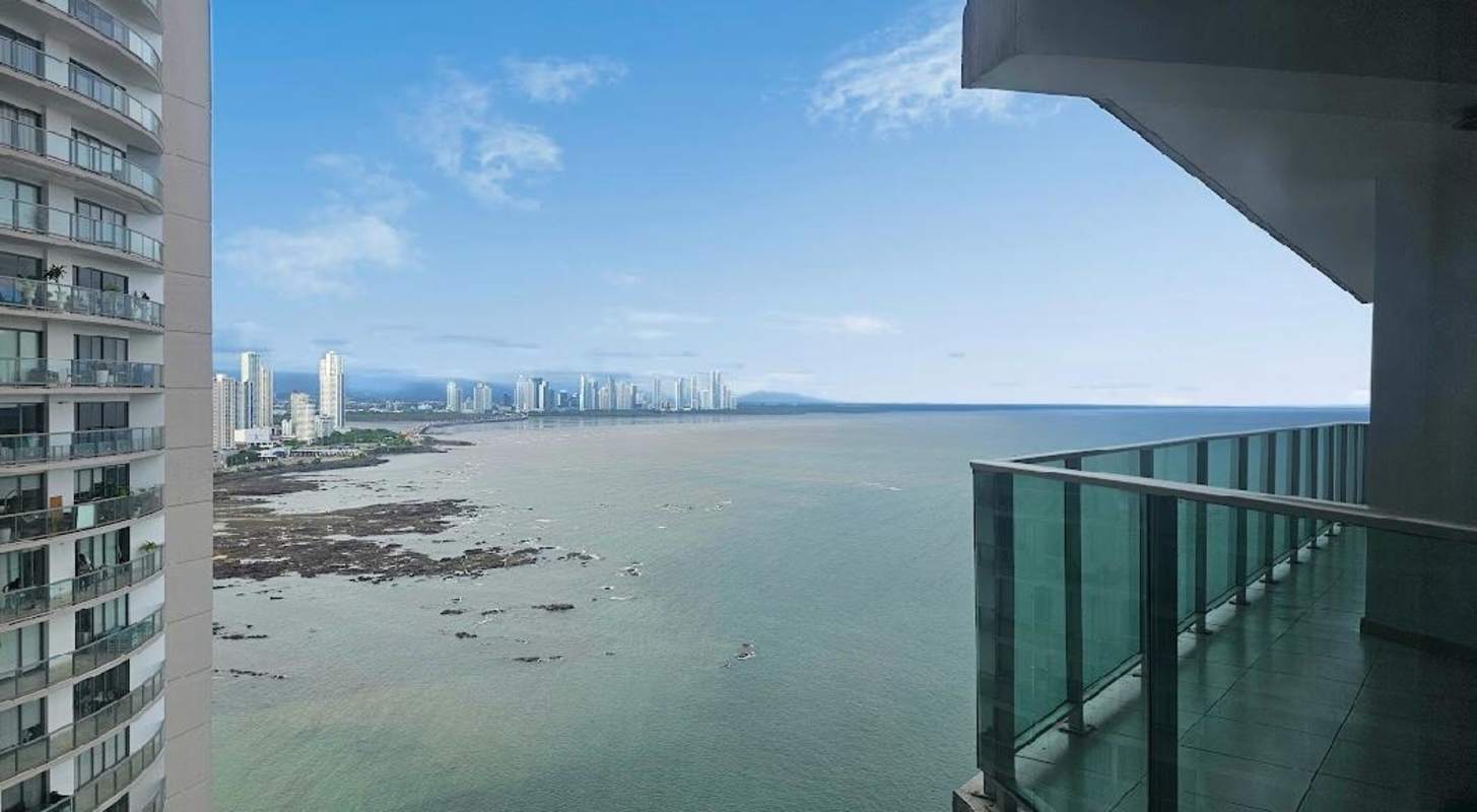 Large private balcony terrace with glass railing overlooking Pacific Ocean in Punta Pacifica Panama