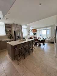 Bright living room in beach condo with large windows and balcony doors Marina Village Panama