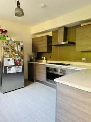 Kitchen area with light cabinetry, appliances ready, Residencial Nativa home Panama