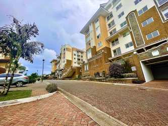 Modern kitchen with quartz countertops, appliances and dining area in Tucan Country Club apartment Panama
