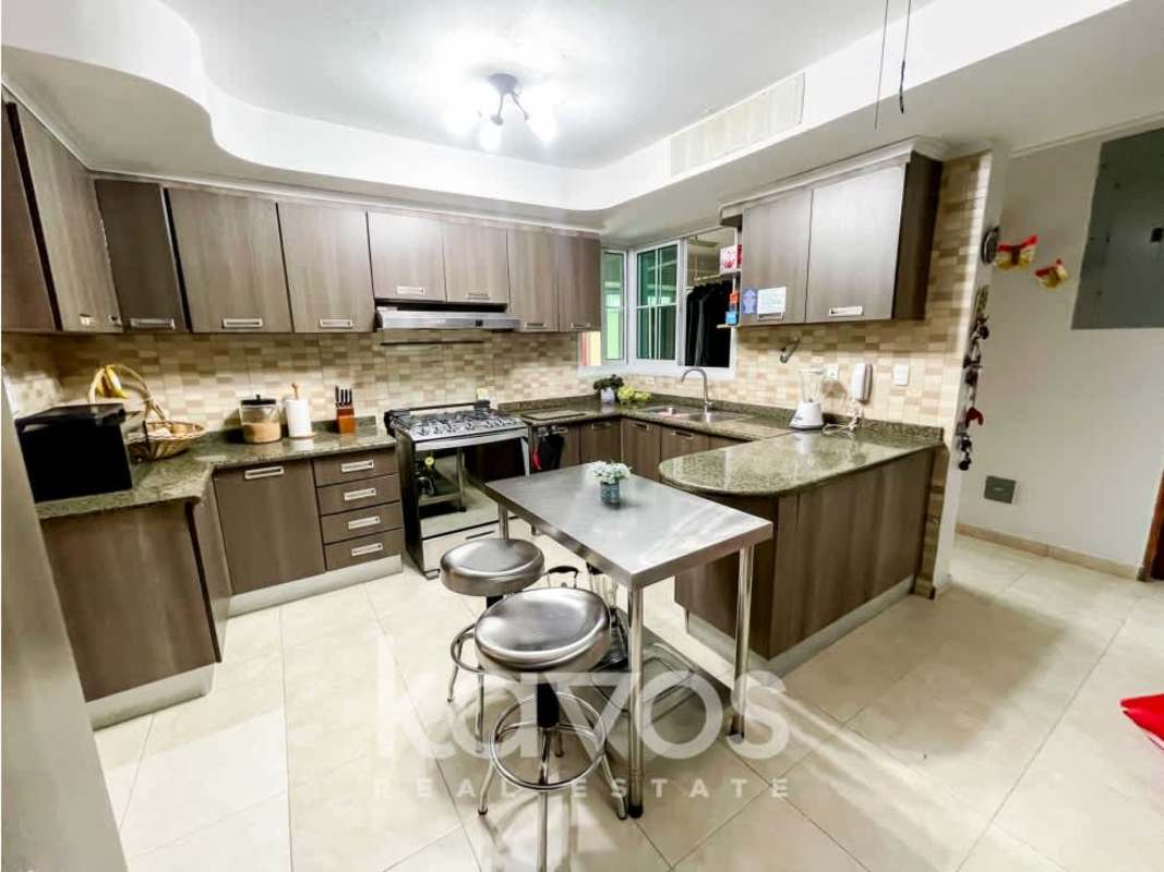 Spacious living and dining room with large windows balcony access at PH Costa Pacifica Panama