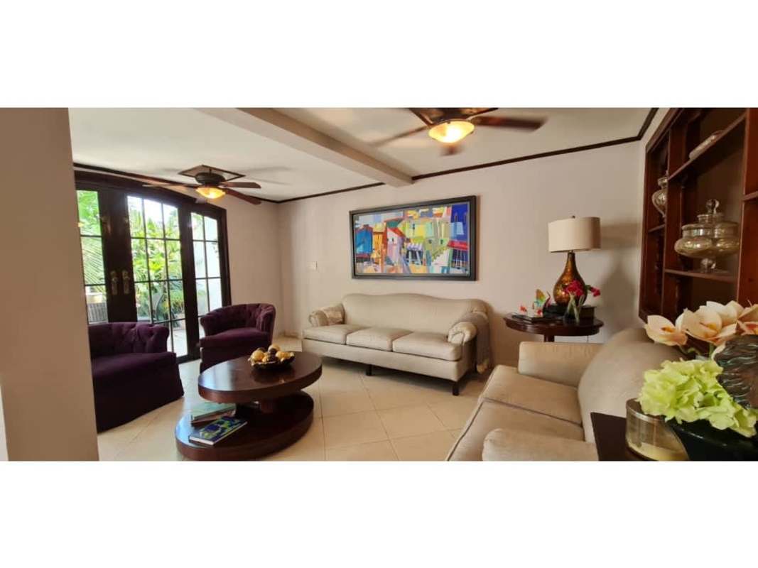 Traditional kitchen with granite countertops, wood cabinets and breakfast area in gated Panama house