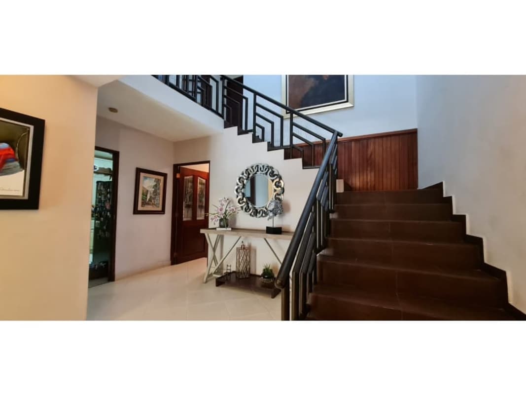 Spacious bedroom with large window and ceiling fan in house at Residencial El Cangrejo Panama