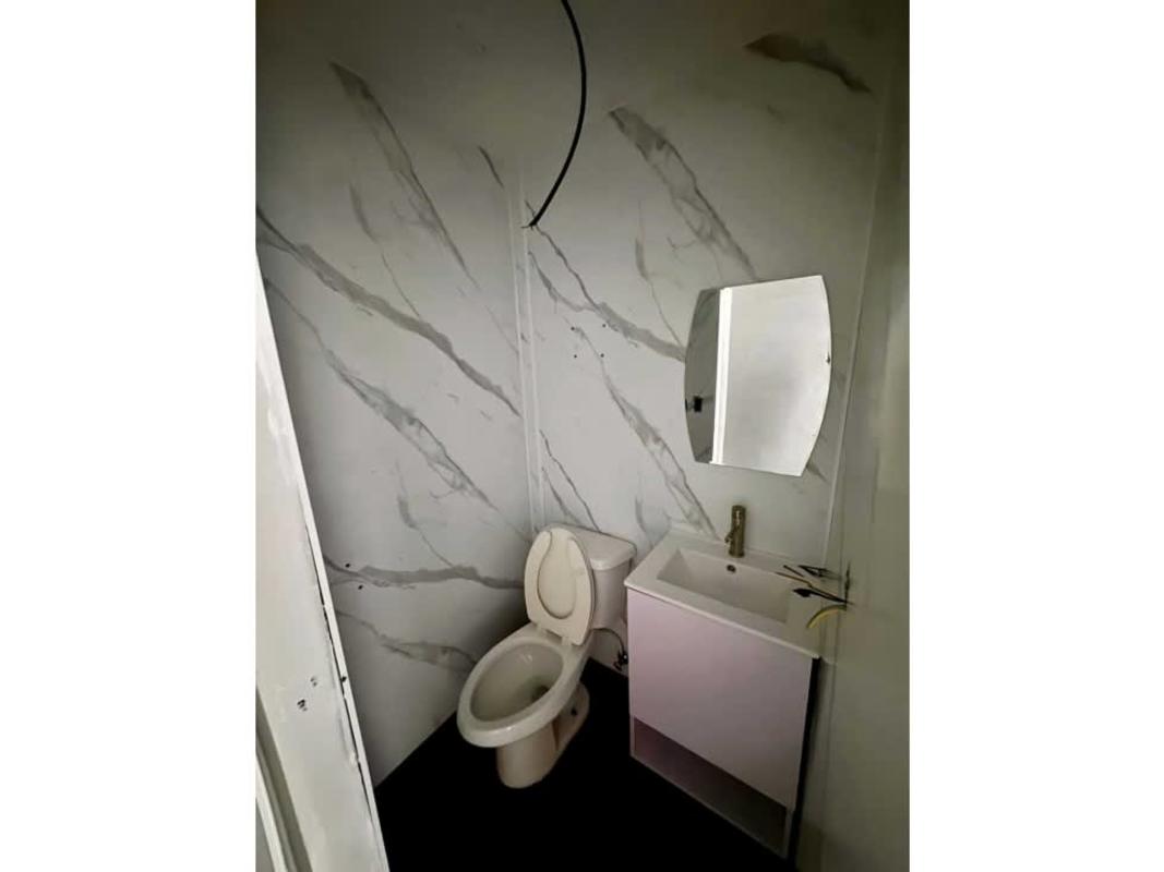 Minimalist bathroom marble wall tiles vanity commercial plaza rental Panama