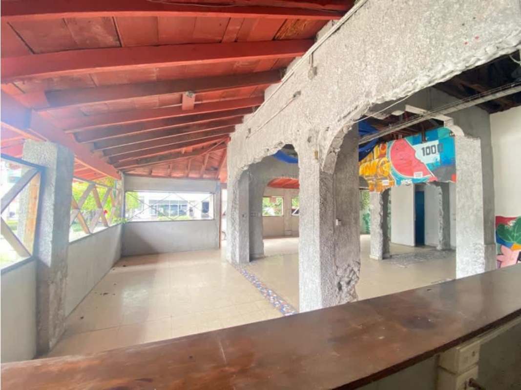 Commercial open plan space with exposed ceiling beams and colorful murals Via Porras Panama