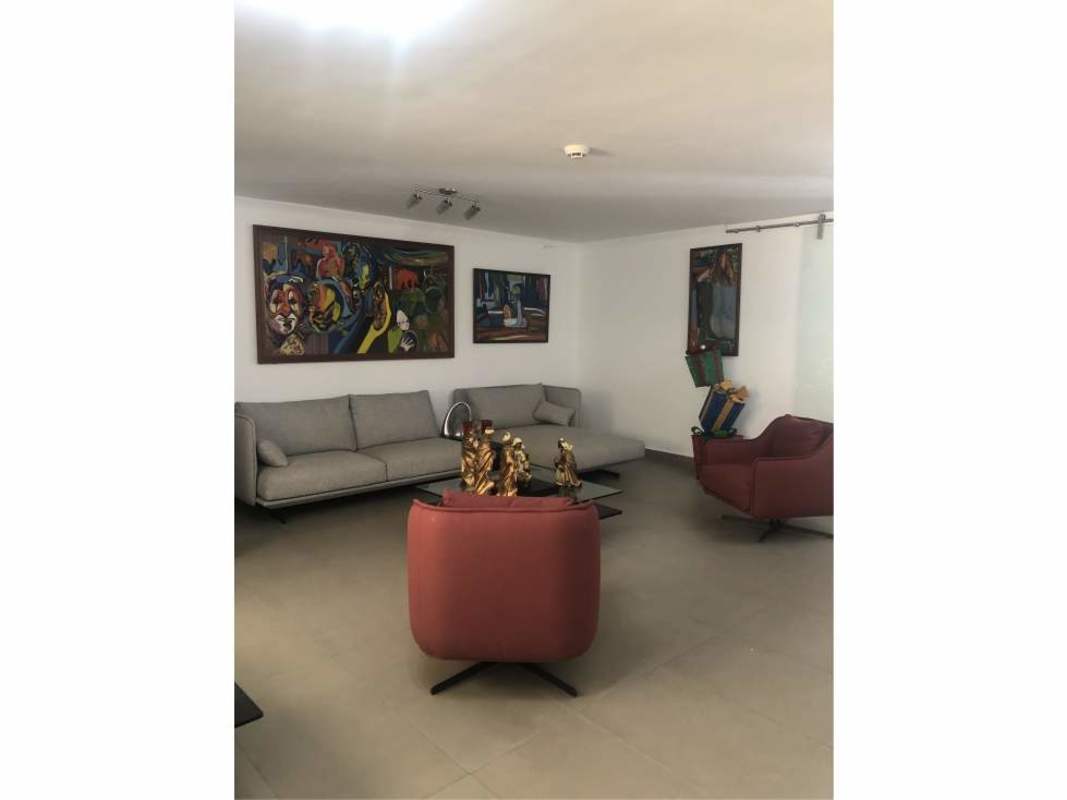 Private swimming pool with tiled patio and sun loungers at luxury house in Obarrio Panama