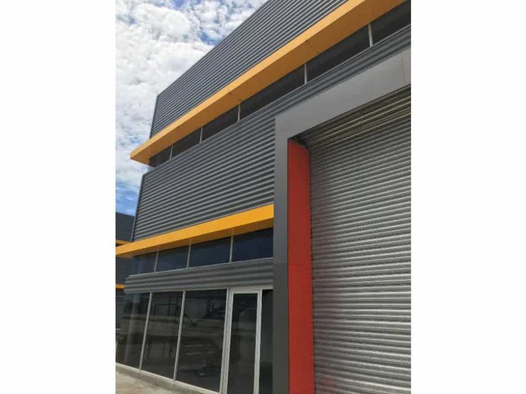 Contemporary facade with large roll-up doors and corrugated metal walls in Juan Díaz Panama