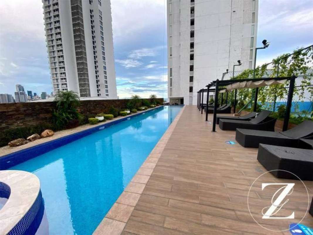 Modern rooftop pool deck with pergolas, sun loungers, city skyline views at PH Rivage Panama City