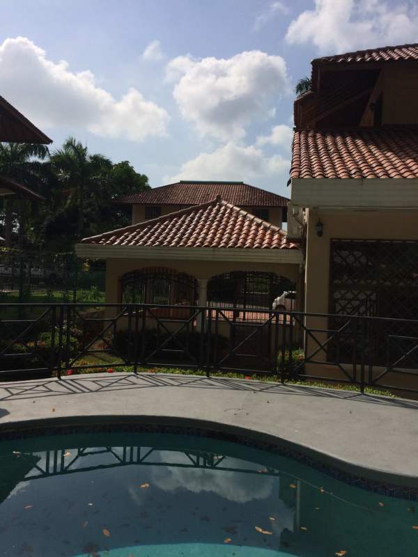 Spacious backyard pool area with terrace and garden in Panama