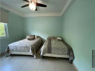 Elegant master suite with en-suite bathroom, AC and balcony access in Bijao beachfront condo