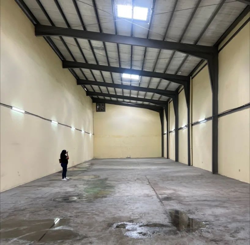 Industrial warehouse interior with high ceiling, metal beams, concrete floor Chanis Panama