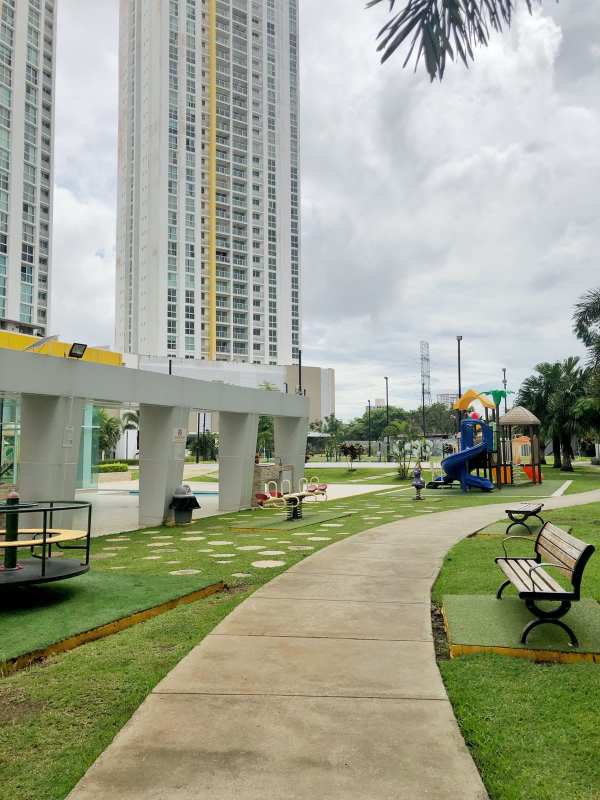 Outdoor playground with slides, play structures, adjacent high-rise towers Condado del Rey