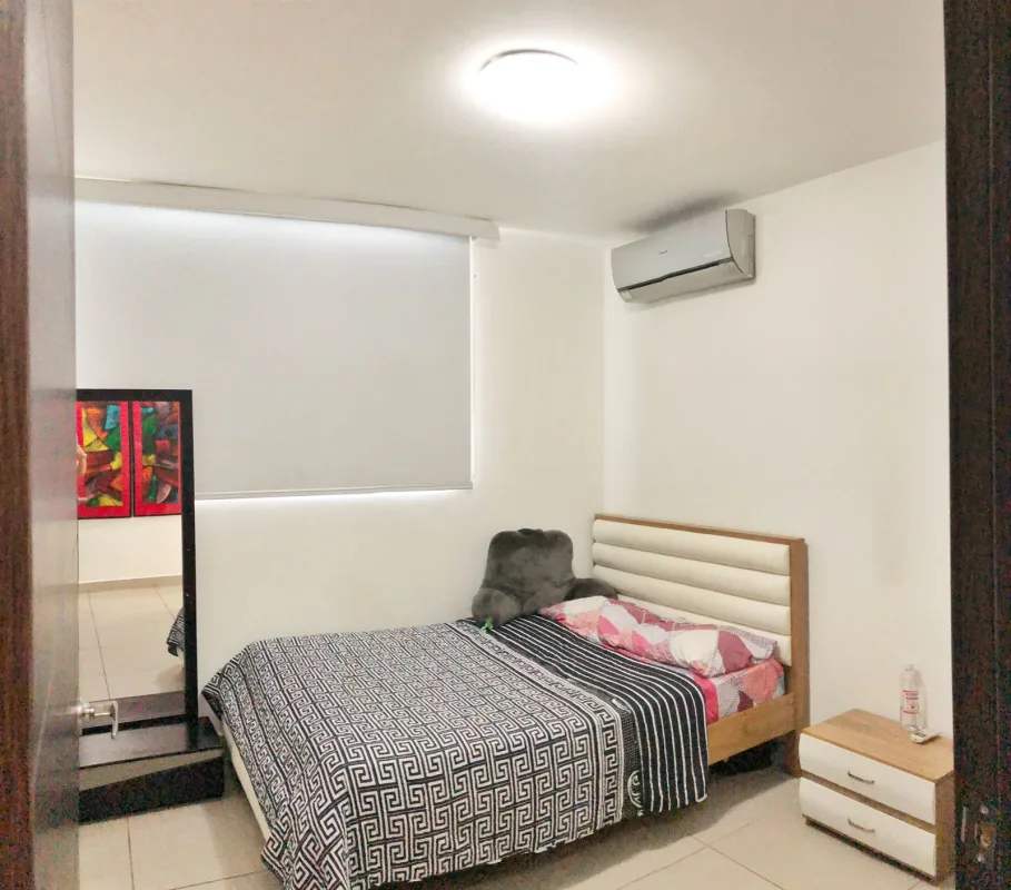 Minimalist bedroom design with window shades, air conditioning unit at Kings Park Condado del Rey