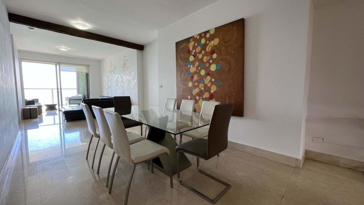 Contemporary fully equipped kitchen with built-in appliances and marble countertops