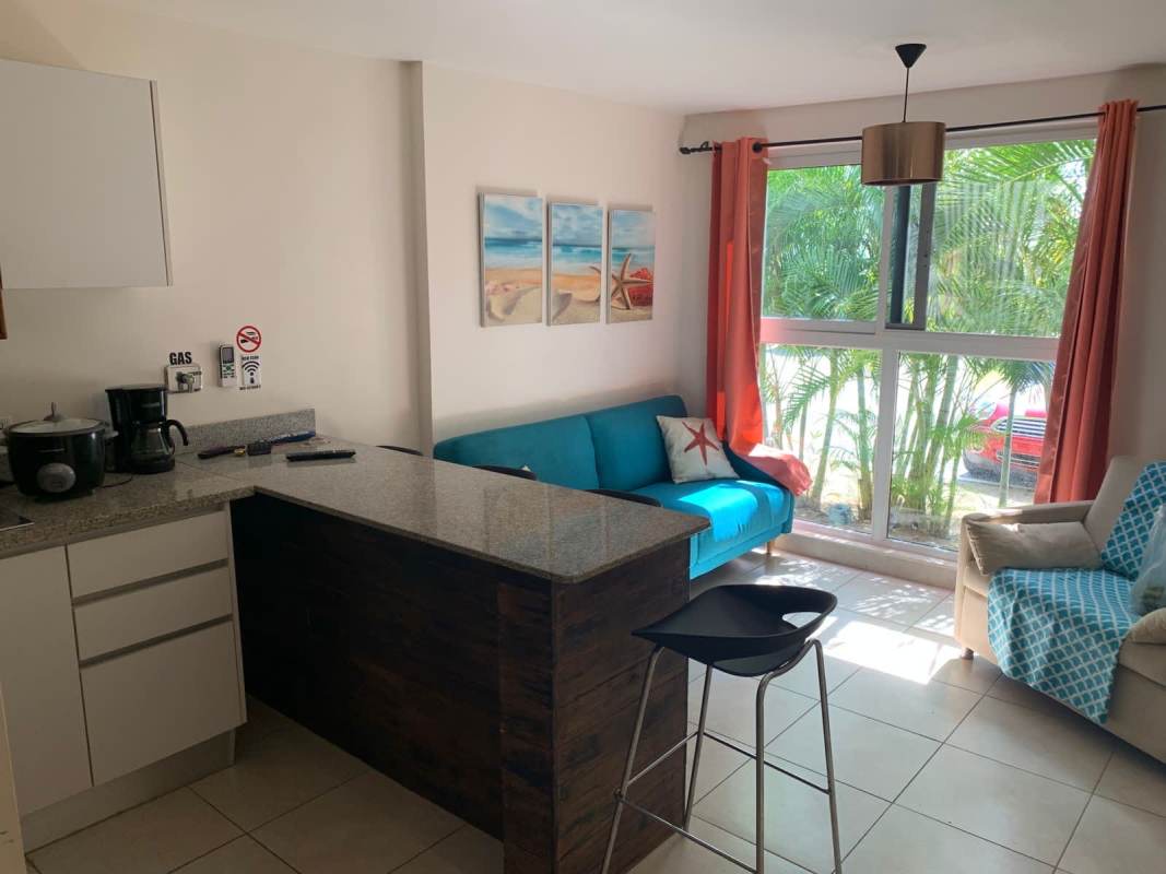 Open concept kitchen with granite counters and appliances Playa Caracol Residences Panama