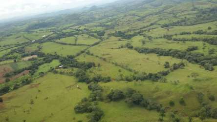Dirt access road with pastures and green hills farmland El Espino Panama
