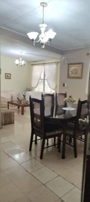 Traditional galley kitchen with white cabinets and appliances in Cerro Viento house