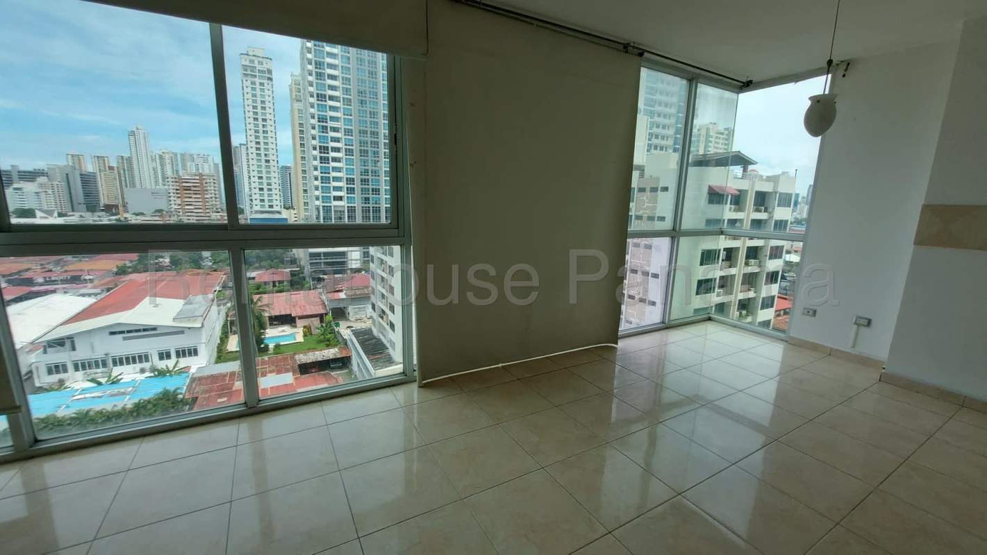 Bright living room with floor-to-ceiling windows overlooking Panama skyline in Sky Blue Tower San Francisco