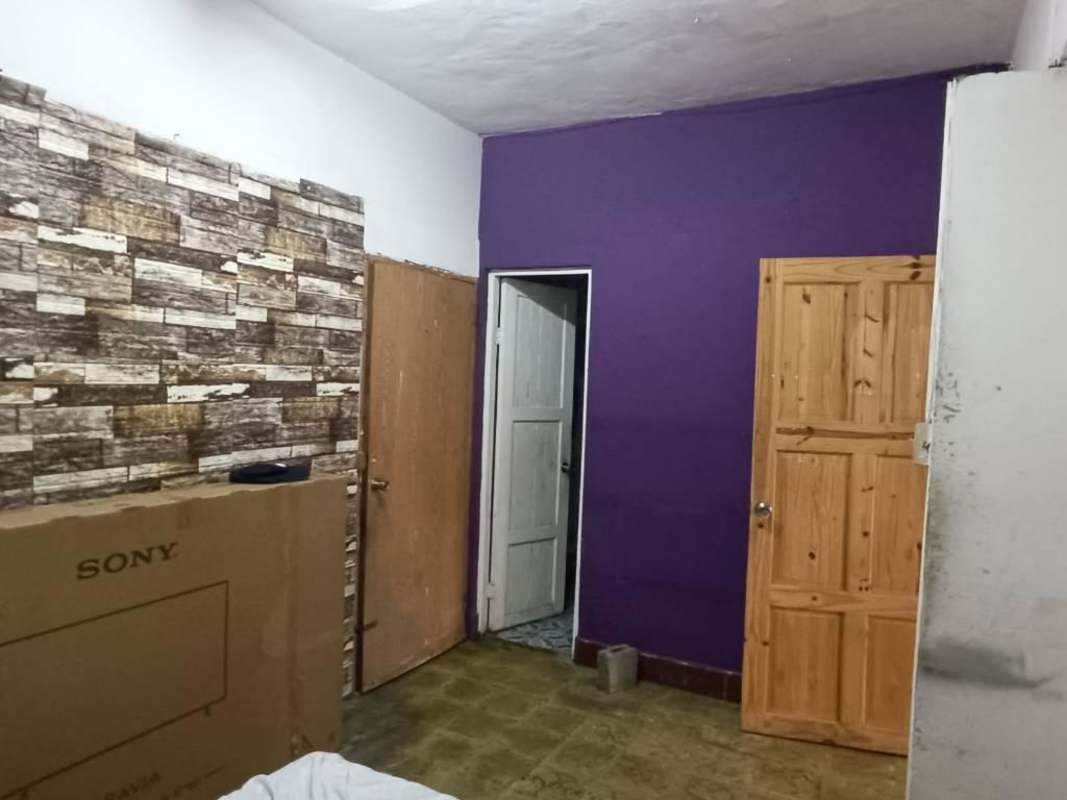 Facade with double iron doors on commercial ground-floor unit Calidonia Panama City