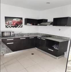 Open kitchen space with granite counters and wall art in PH Ibiza Beach Villa Panama