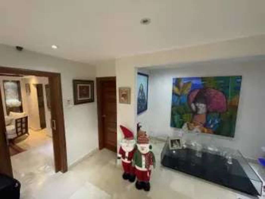 Entrance foyer with art, marble floors, and festive decor in luxury home Clayton Panama