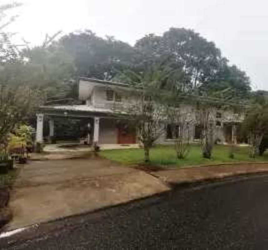 Spacious living room with stone accent wall, modern furniture, overlooking garden in Clayton Panama
