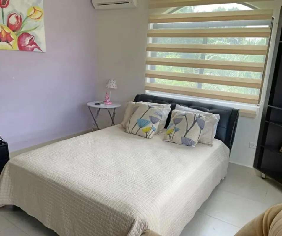 Bright living room with neutral tones, Mediterranean arches and large windows in Clayton Panama home