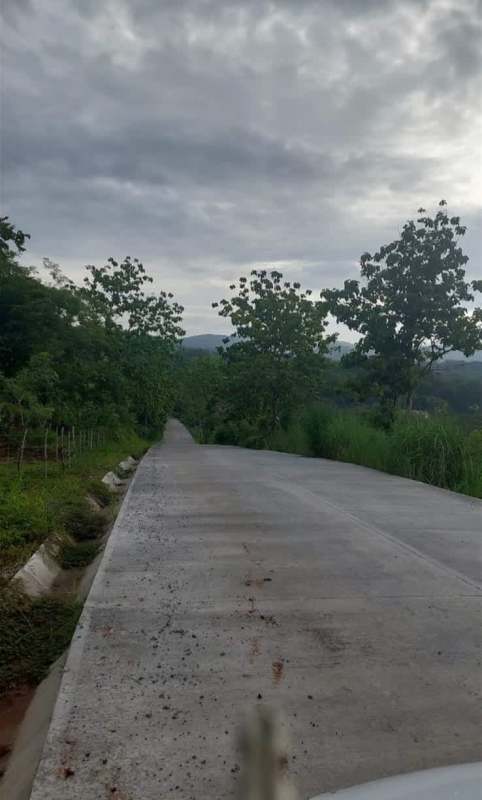 Concrete paved road by lush countryside ideal for development near Las Cumbres Panama City