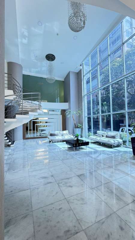 Double height lobby with marble flooring and modern design at PH Astoria Panama City