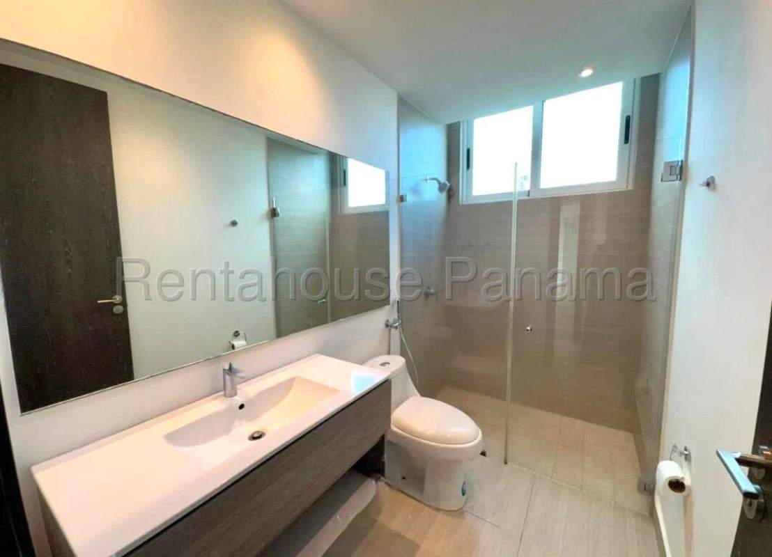 Ensuite bathroom with glass-enclosed shower modern vanity at PH Asia Panama apartment rental