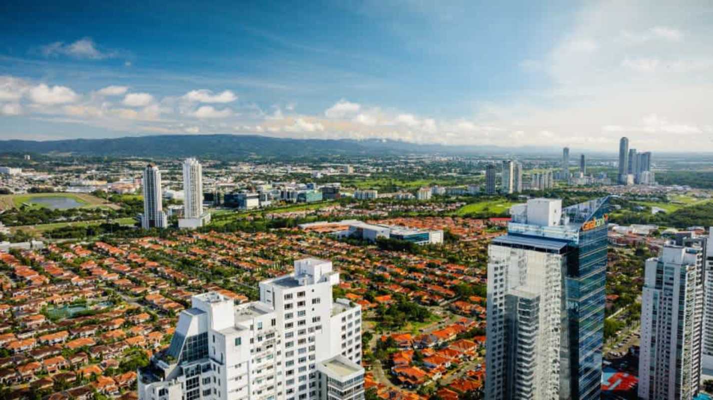 Resort-style infinity pool overlooking ocean and greenery in Santa Maria Condo