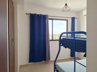 Bright bedroom with window to ocean in PH Playa del Sol San Carlos