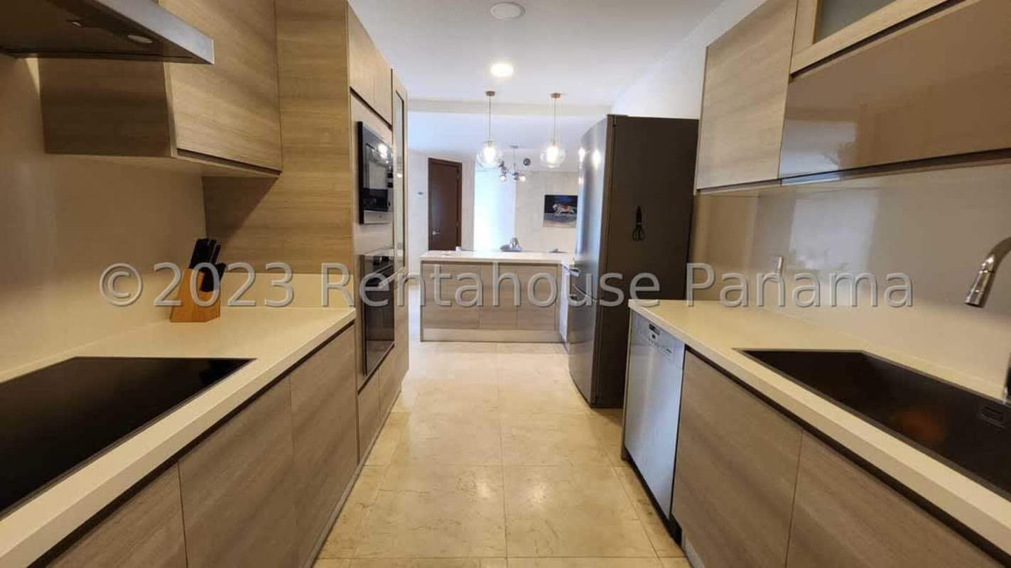 Spacious living area with marble floors and balcony with golf course views