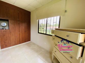 Bedroom with large window overlooking garden in Panama beach house for sale