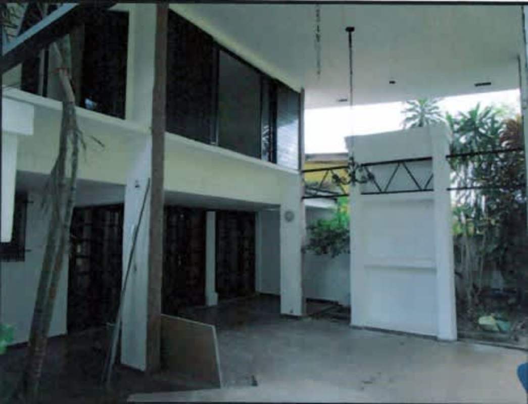 Minimalist kitchen dining area with black cabinets and white floor Pueblo Nuevo Panama