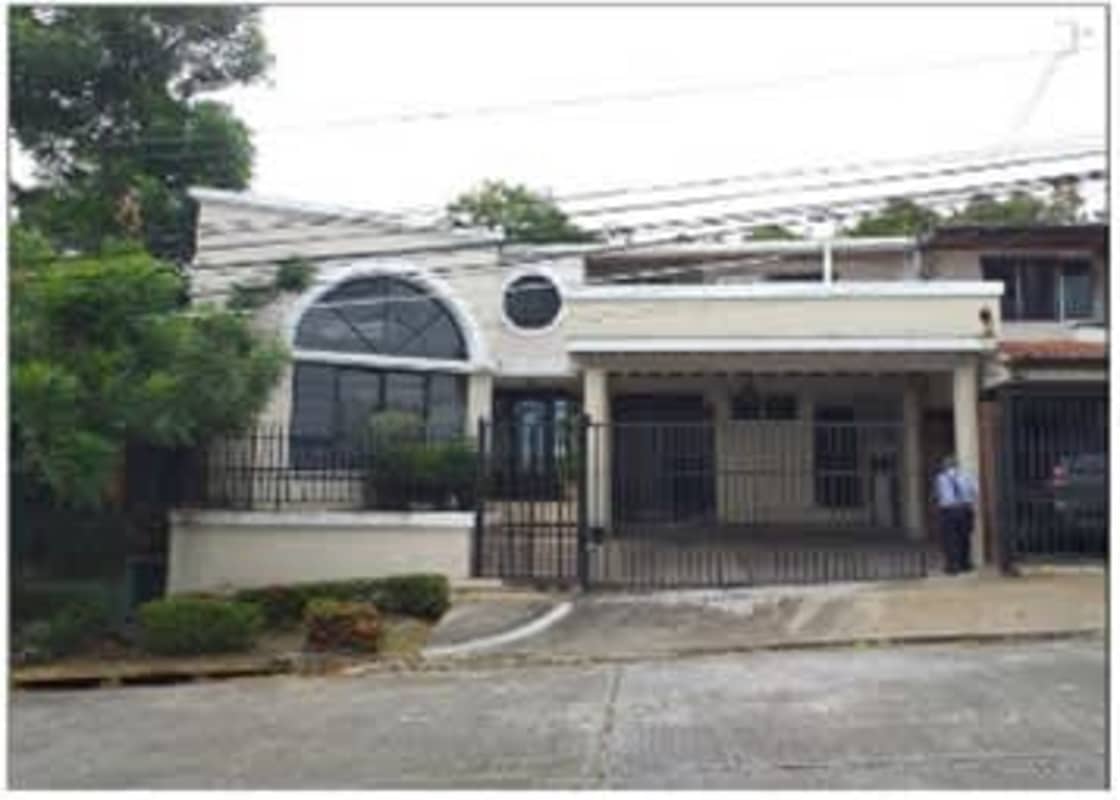 Front view two-story house gated parking semicircular window La Loma Panama